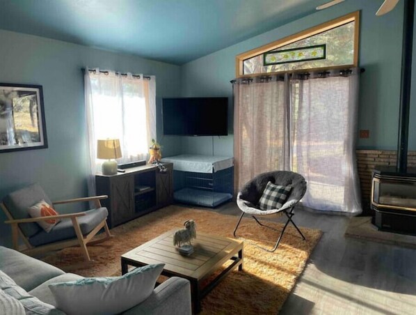 A living room with a sofa, coffee table, and a TV.