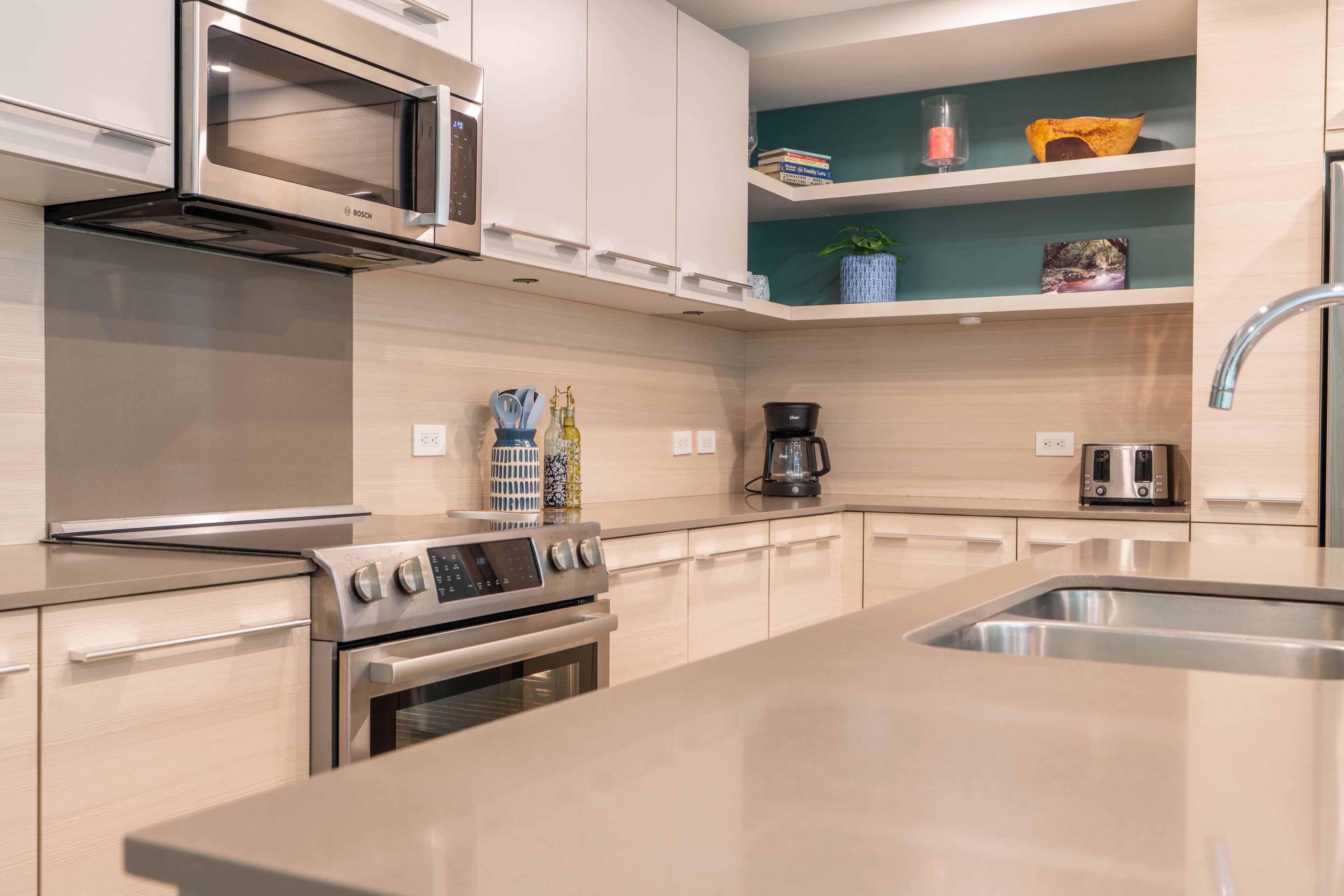 A modern kitchen with stainless steel appliances, a built-in oven, and a microwave.
