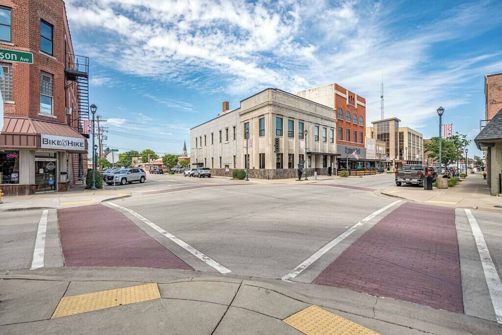 A street view with buildings, a bike lane, and a clear sky.