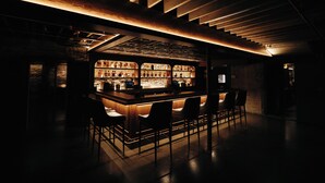 A bar area with a wooden ceiling and bar stools. - The Exchange. Big Luxury Loft, XCHNG. Modern Loft in the heart of Effingham.  (Effingham)