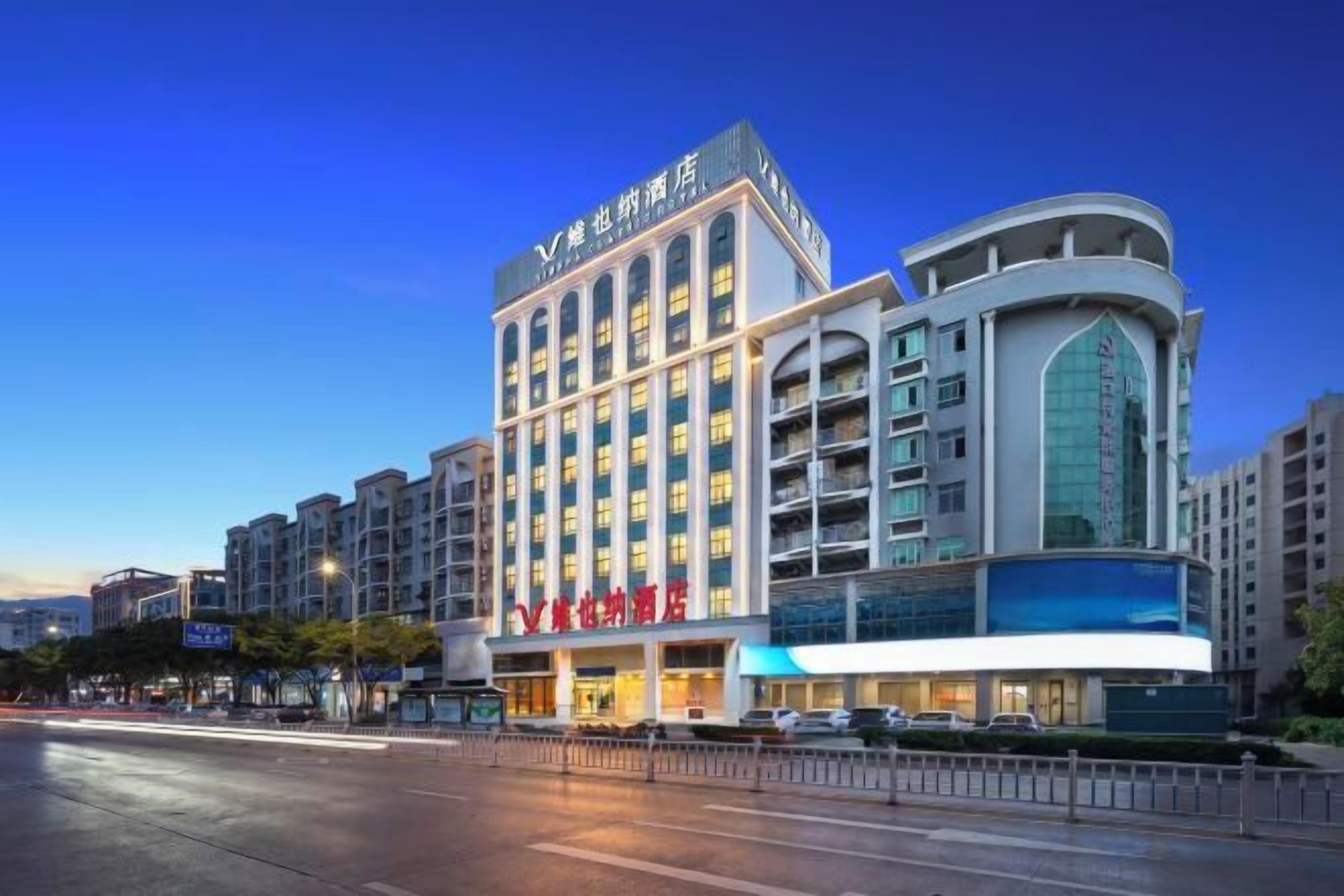 A multi-story hotel with a modern design, featuring a prominent entrance and a curved facade.