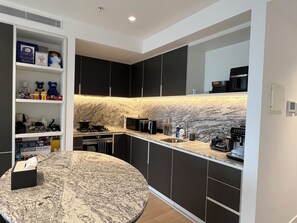 Enjoy cooking in this well-equipped kitchen with an oven, sink, coffee maker, and microwave.