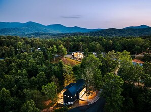 Exterior - Letting Geaux is a modern mountain retreat built for elevated stays. Enjoy a private hot tub, game room with pool table, expansive decks, and fire pit. Perfect for spring getaways, slow mornings, and relaxed evenings under the stars. (Young Harris)