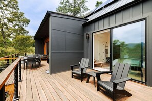 Outdoor dining - Letting Geaux is a modern mountain retreat built for elevated stays. Enjoy a private hot tub, game room with pool table, expansive decks, and fire pit. Perfect for spring getaways, slow mornings, and relaxed evenings under the stars. (Young Harris)