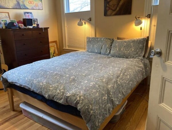 A bedroom with a bed, dresser, and wall-mounted lamps. - Beautiful, family-friendly home with yard and patio near Tufts, 10 min to Boston (Medford)