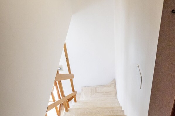 A staircase with wooden handrails leading to a landing.