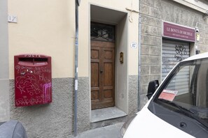 A building with a wooden door and a mailbox with graffiti.