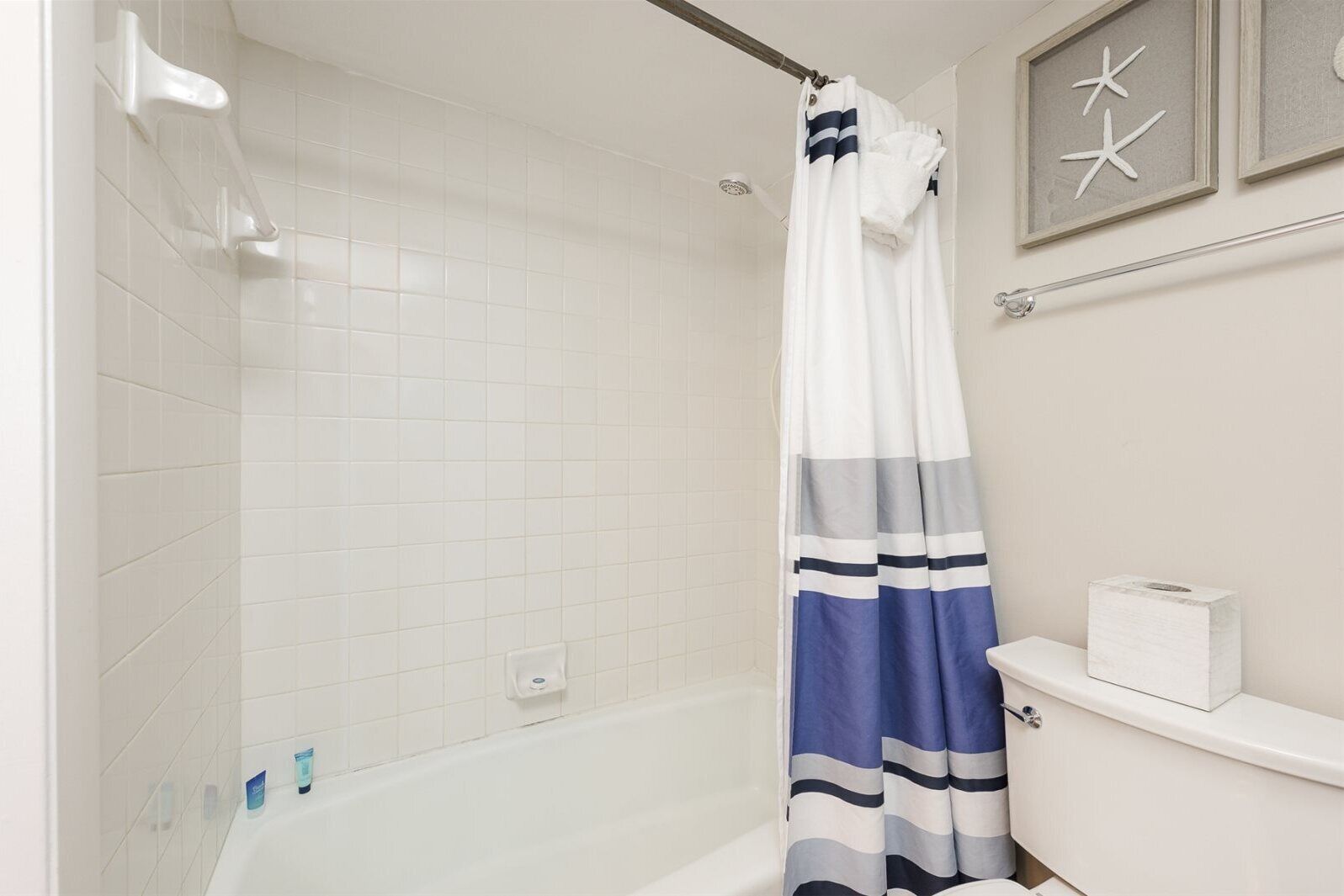 A bathroom with a shower, a bathtub, and a toilet.