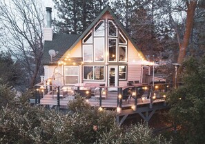 A two-story house with a deck, large windows, and a chimney. - Treetop A-frame Cabin, Family Friendly w/a Jacuzzi
 (Lake Arrowhead)