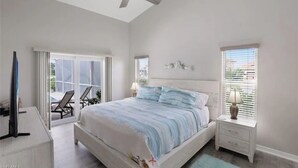 A bedroom with a bed, a nightstand, a ceiling fan, and a window with blinds. - Tropical Vacation Home Marco Island Florida - Close to Beaches-Pet Friendly-POOL (Marco Island)