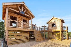 A wooden playhouse with a slide and a small window. - Near Indoor & Outdoor Pools: Hot Tub, Game Room & Free Silver Dollar City Tickets (Kimberling City)