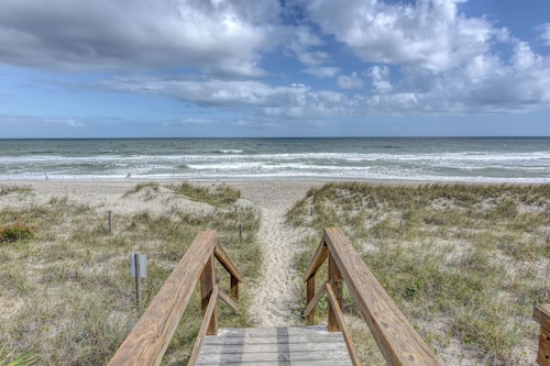 10 steps away till sand in your toes on the ocean front in Carolina Beach, NC.
