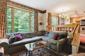 Bright, Open Living Area - Large windows fill the room with natural light, creating a welcoming place to relax with family and friends.