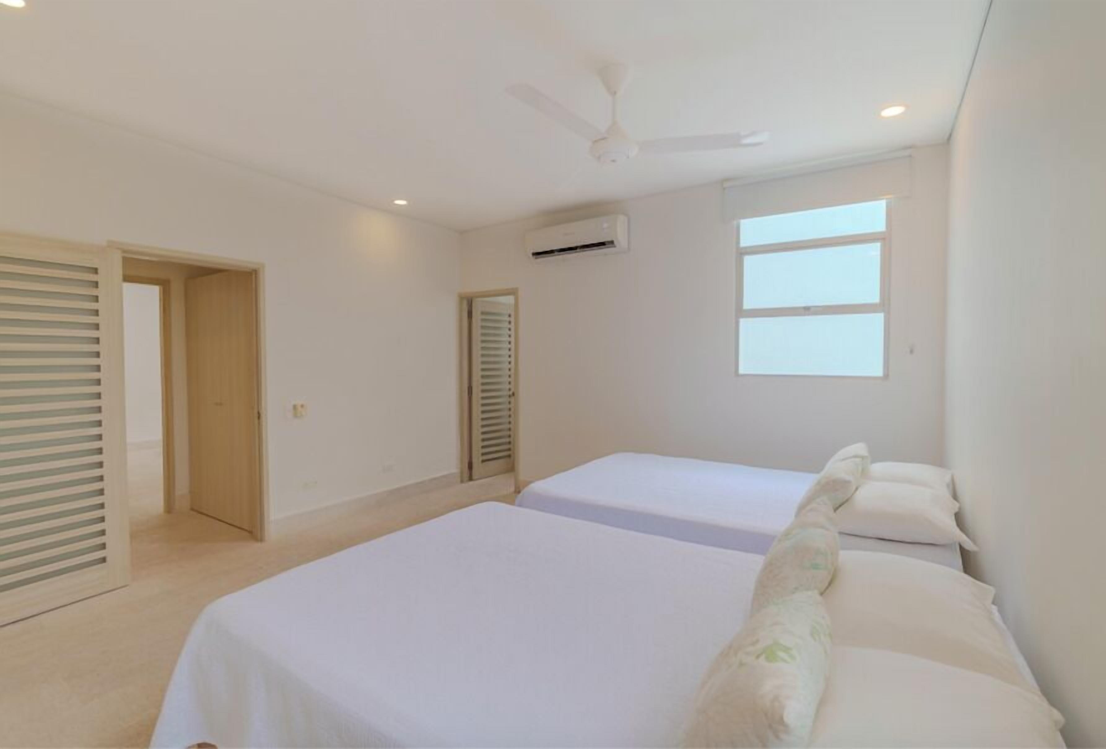 Premium bedding, memory-foam beds, desk, laptop workspace