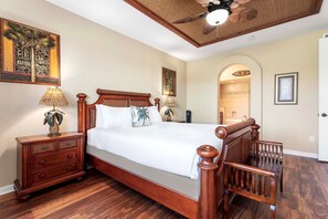 A bedroom with a wooden bed, nightstands, a ceiling fan, and artwork on the walls. - 🏖️Near A-Bay Beach | Golf View Condo | Waikoloa Beach Villas N3 (Waikoloa)