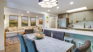 A modern kitchen with a central island, dining area with chairs, and a sofa. - Hot Tub: Family Gem 3 Mi to Frisco Nordic Center (Frisco)