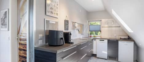 Fridge, stovetop, dishwasher, coffee/tea maker