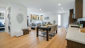 A modern apartment with a dining area, kitchen, and living room. - Perch - View Ridge Guest Suite: Cozy 1BR ADU Retreat (Seattle)