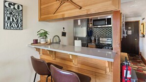 A modern kitchen with a wooden island, stainless steel appliances, and a fire extinguisher. - TahoeCozy Woodland Retreat • Pool • Hot Tub • Beach (Tahoe Vista)