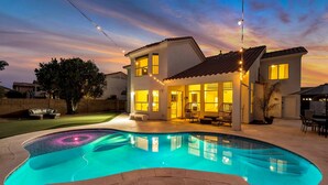 A house with a swimming pool, outdoor lighting, and a patio area. - Private Heated Pool, Putting Green, Pool Table, BBQ, WIFI, Near Golf, Dining & Mayo Clinic+FREE GOLF (Scottsdale)