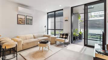 Deluxe Apartment | Living area | 50-inch Smart TV with digital channels, Netflix, streaming services