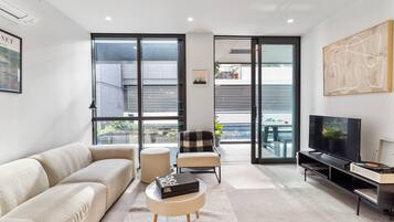 Deluxe Apartment | Living area | 50-inch Smart TV with digital channels, Netflix, streaming services