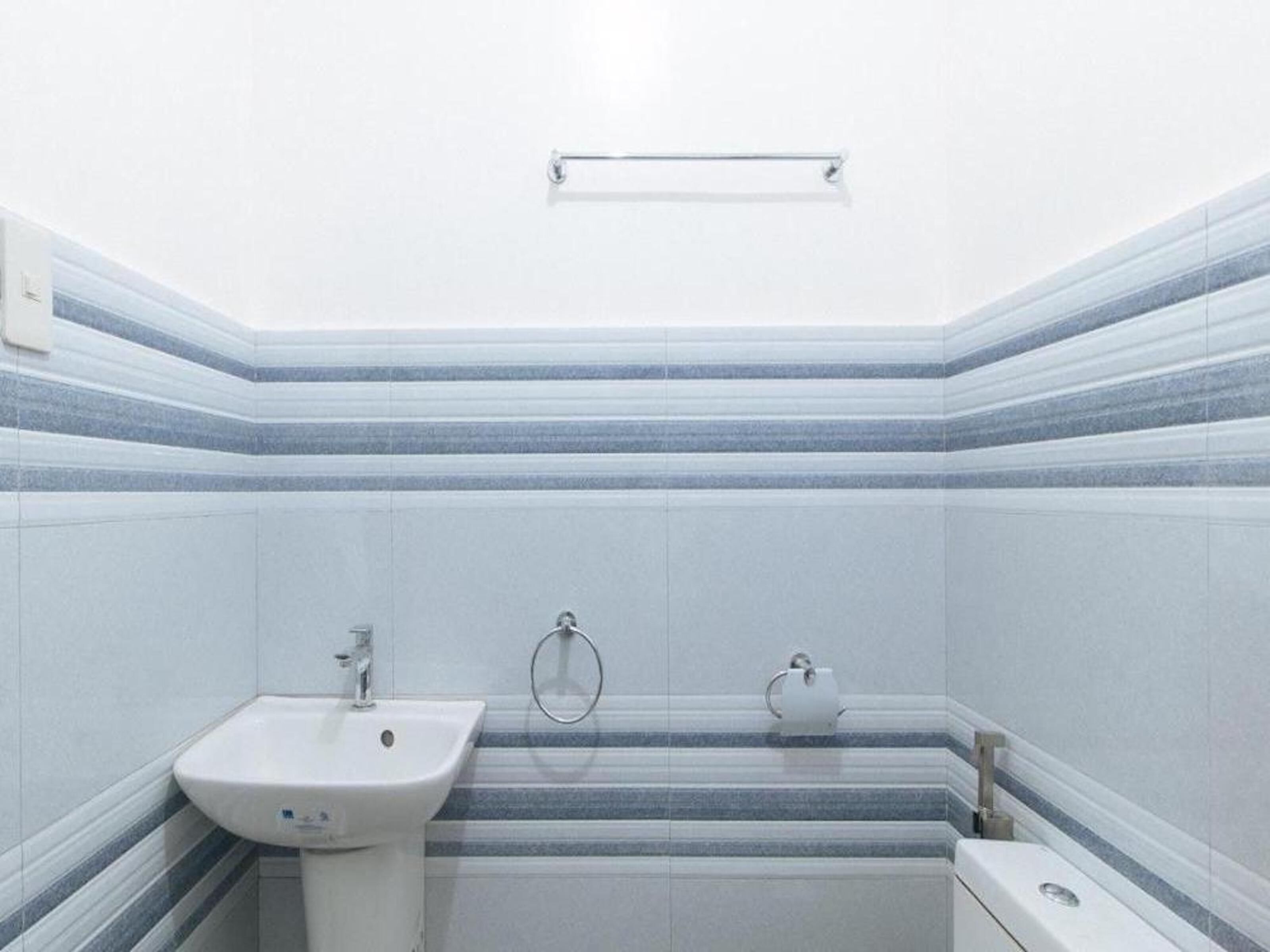 A bathroom with a white sink, a toilet, and a bathtub.