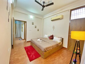 Cozy retreat with a large bed, air conditioning, and a ceiling fan.