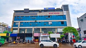 A multi-story hotel with a sign reading "HOTEL BLUE MOON" and "FAB HOTEL." - Fabhotel Blue Moon I (Ahmedabad)