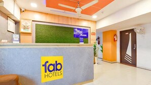 A hotel reception area with a sign for 'Blue Moon' and 'Fab Hotels'. - Fabhotel Blue Moon I (Ahmedabad)