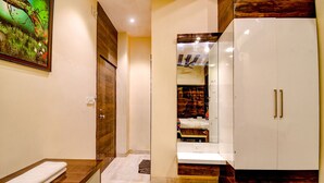 A modern bathroom with a wooden vanity, a white sink, and a large mirror. - Fabhotel Abis Inn (Kolkata)