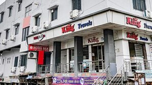 A building with multiple signs for 'Fab Hotels' and 'Hotel Silk'.