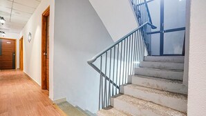 A staircase with metal railings leading to a landing.