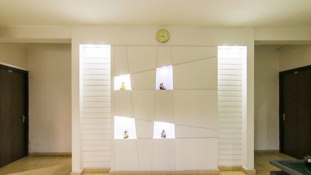 A room with a large wall-mounted clock, a wooden floor, and a window with blinds. - FabHotel Gazelle Inn (Gurugram)