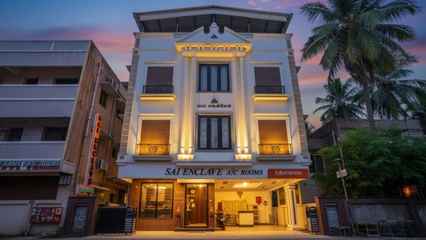A building with a sign for "SAI ENCLAVE A/C ROOMS" and a "fabexpress" sign. - FabHotel MM Residency (Chennai)