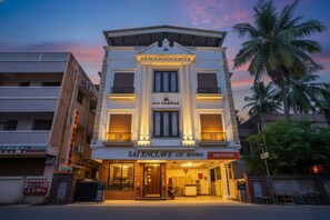 A building with a sign for "SAI ENCLAVE A/C ROOMS" and a "fabexpress" sign. - FabHotel MM Residency (Chennai)