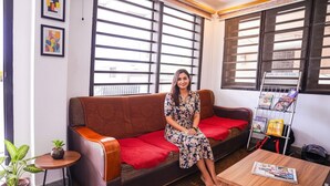 A room with a sofa, a small table, and a magazine rack. - FabHotel MM Residency (Chennai)