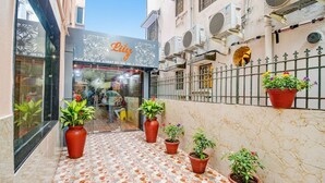 A storefront with a floral sign and potted plants outside. - Fabhotel The Lily (Kolkata)