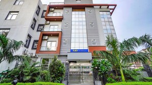 A modern multi-story building with a prominent 'fab hotels' sign. - Fabhotel 17 Suites (Noida)