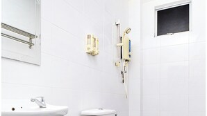 A bathroom with a white sink, toilet, and shower. - Collection O 88 Hotel (Malacca City)