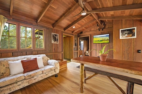 Living area. Romantic timber cabin on 75 acres with outdoor bath