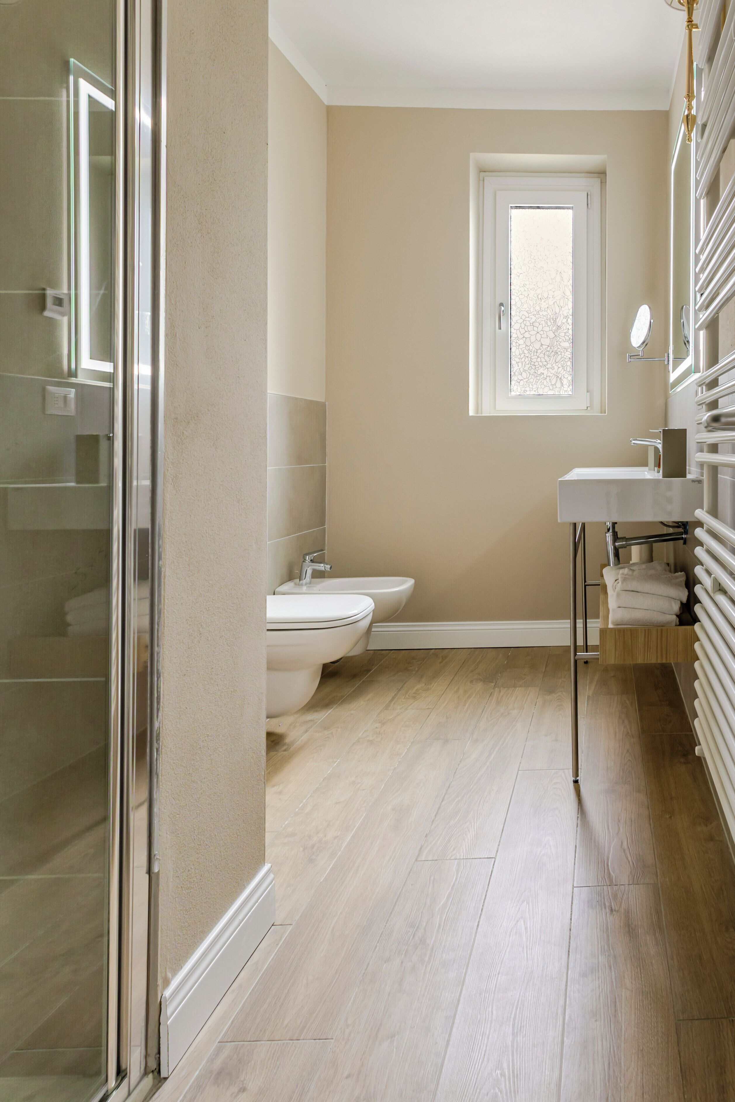 A bathroom with a toilet, sink, and shower.