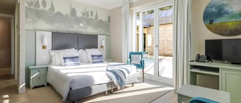 A bedroom with a bed, bedside tables, a desk, a chair, a TV, and a painting on the wall.