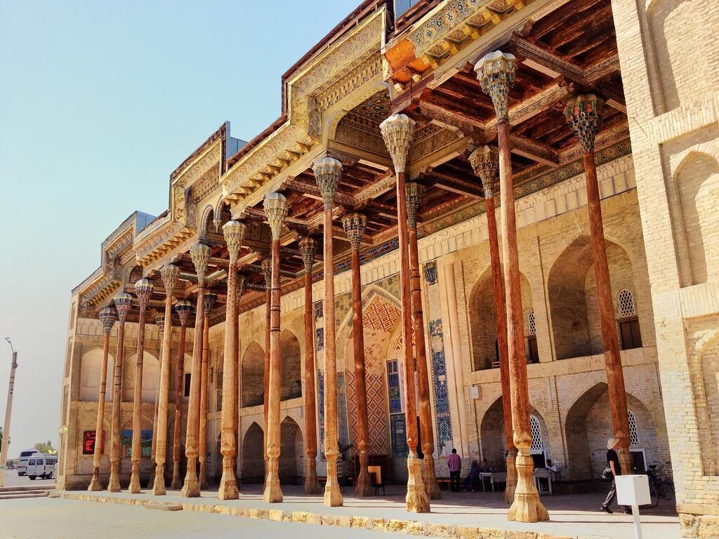A historic building with a series of arches and columns, featuring intricate architectural details.