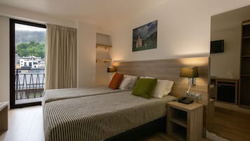 Basic Double Room | Minibar, in-room safe, desk, blackout drapes