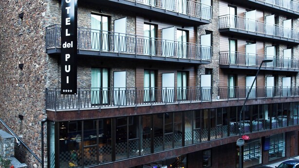 A multi-story hotel with balconies, large windows, and a stone facade. - Hotel del Pui by Nexta (La Massana)