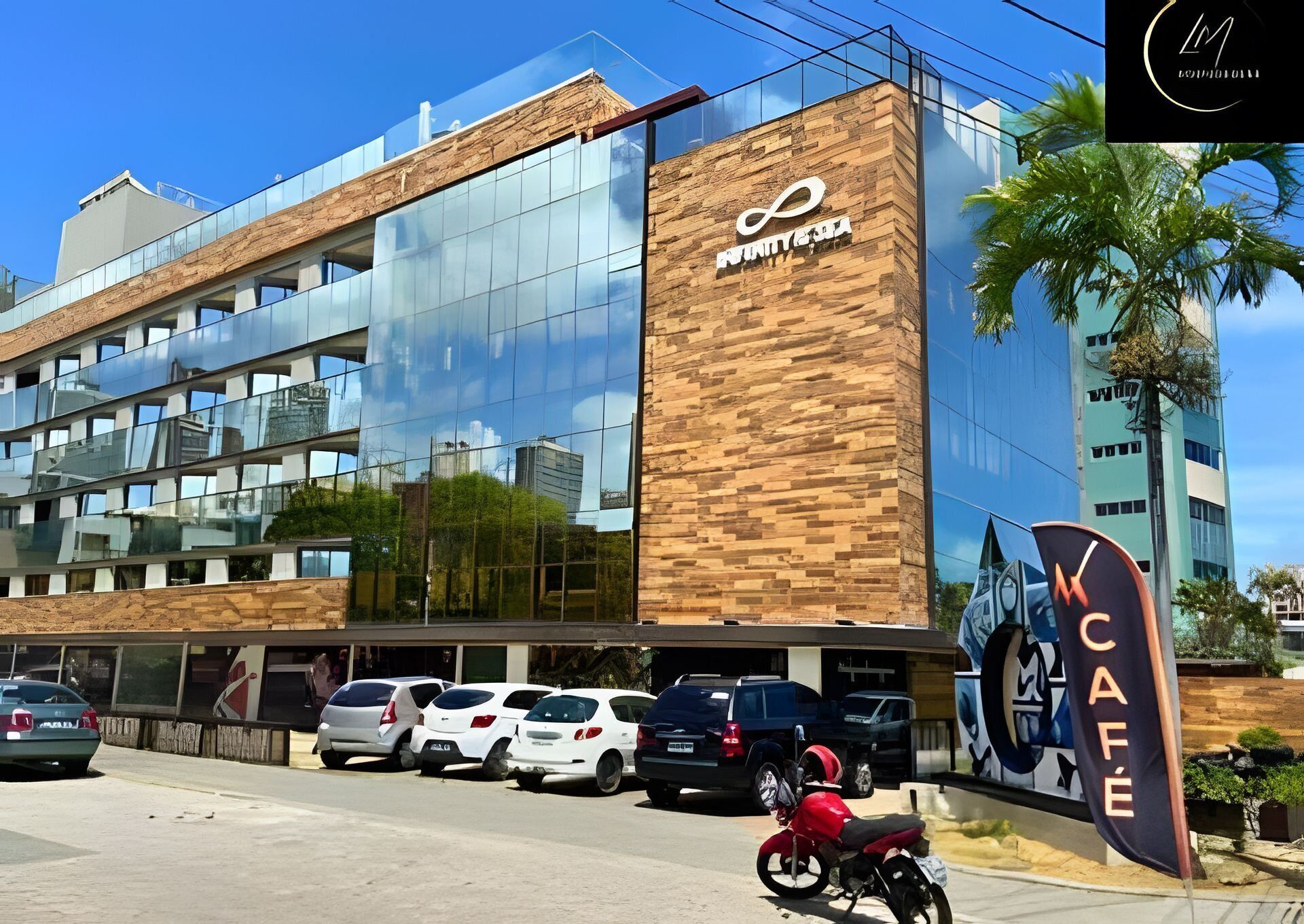 Un bâtiment moderne doté d’une façade en verre, d’un mur à l’aspect bois et d’une enseigne indiquant « Unity Cafe ».