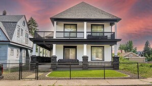 A two-story house with a balcony and a front porch.