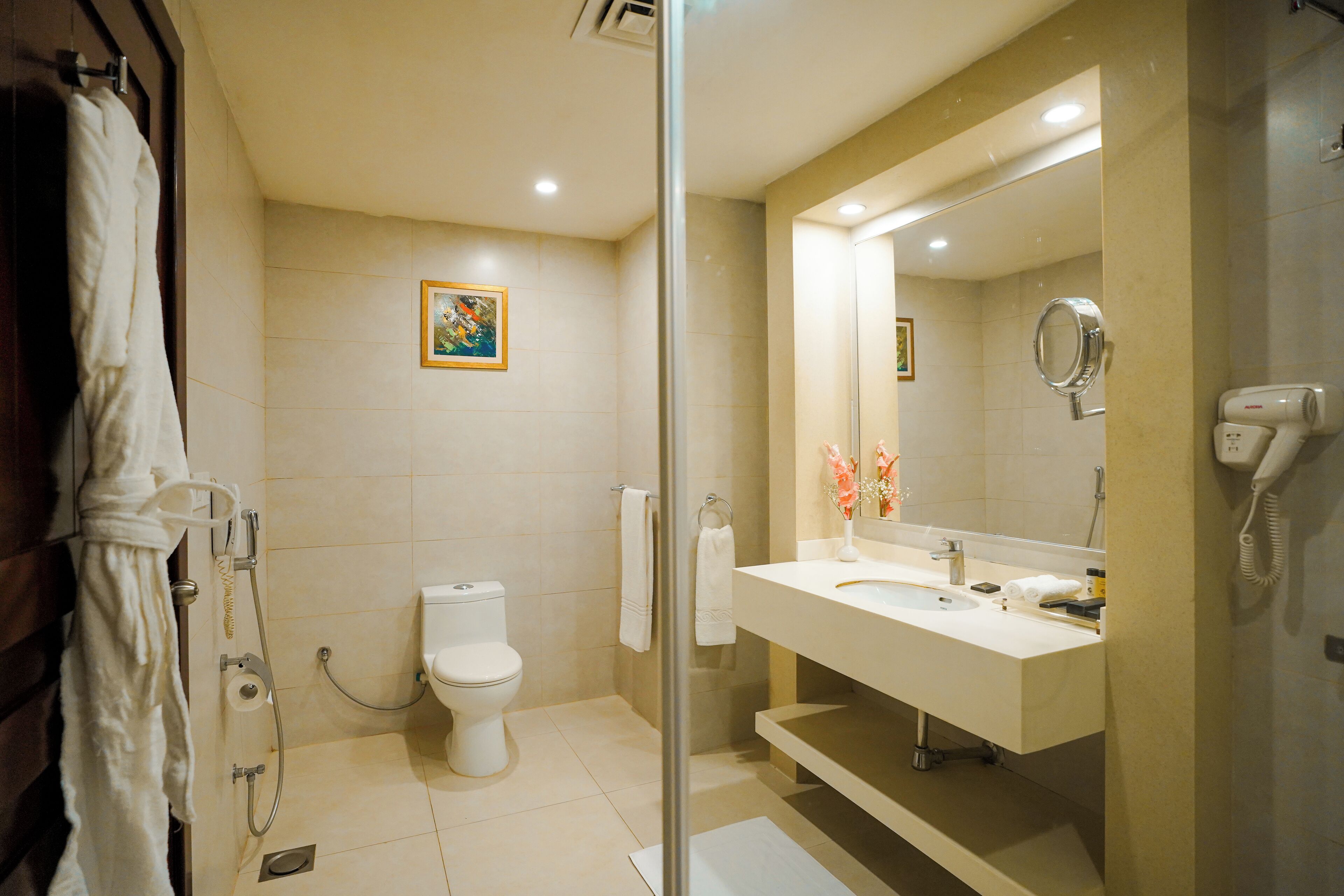 A modern bathroom with a toilet, sink, and shower.