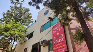 A building with a sign for Harish Dhaba & Guest House, including contact numbers. - Harish Guest House -Railway Station Road (Chandigarh)